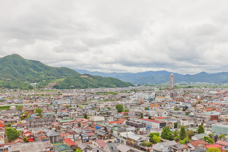 KAMINOYAMA, JAPAN - MAY 28, 2017: View of Sankichiyama Mount and Kaminoyama City from donjon of Kaminoyama Castle. Sky Tower 41 skyscraper is in the right cornerのeditorial素材