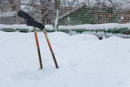 Two hockey sticks in a snowdrift, day. copyspace.の写真素材