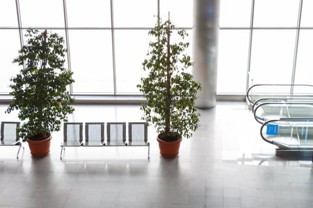Bright daylight from the windows inside the mall next to the escalator.の写真素材