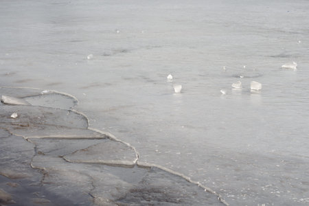 Thin cracking river ice. seasonal melting.