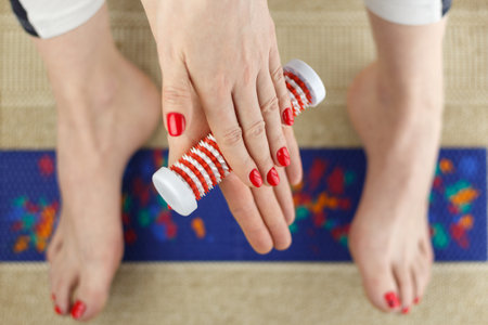 Hands and feet of a woman with massagers, selective focus.の写真素材