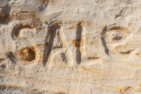 Word Sale squeezed out in the sand.の写真素材