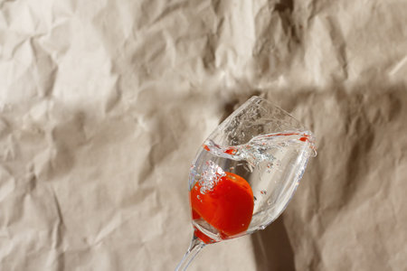 Small tomato fell into a glass of water, copy spaceの写真素材