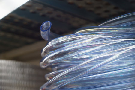 Transparent elastic hose for liquids rolled up on a shelf. Selective focus.の写真素材