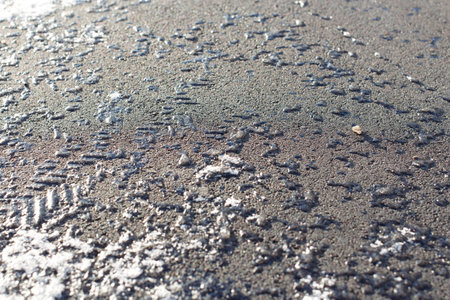 Small pieces of ice frozen to the asphalt. Soft focus.の写真素材