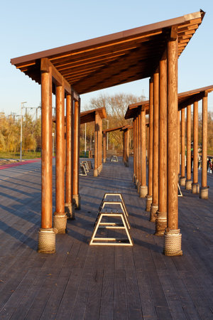 Wooden veranda with high roof in a fall park at sunset.の写真素材