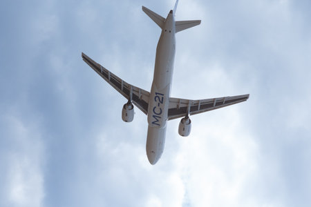 Passenger aircraft MS-21-300 in the sky, bottom-up view. Zhukovsky, Russia, July 24, 2021.のeditorial素材