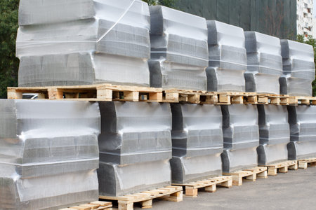 Road curbs on pallets in the city on the street. Road repair.