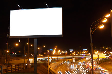 Large horizontal billboard near the night highway.の写真素材