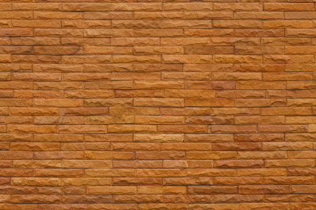It is orange slate stone wall for pattern and background の写真素材