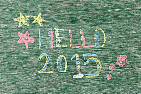 Hello 2015 written on wooden board by using chalk.