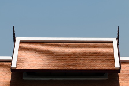 It is Orange roof tiles with blue sky background.の写真素材