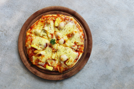 it is mini pizza on wooden plate.の写真素材