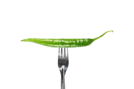 it is fork pricks green chili isolated on white.の写真素材