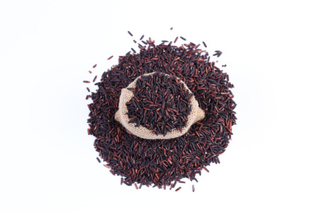 rice berry in sack bag isolated on white.の写真素材