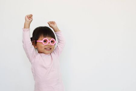 happy smiling asian girl wears glasses and hand up.の写真素材