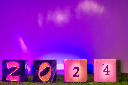 New Year 2014. Number on wooden cubes with neon light background.の写真素材