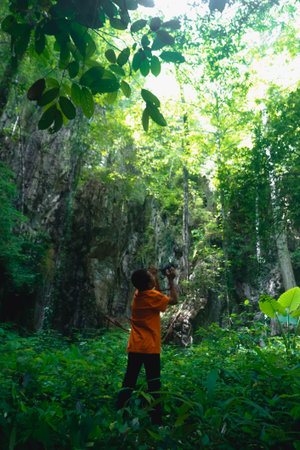Woman take photo with camera in the forest at Phu Kradueng National Park, Loei, Thailand