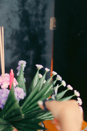Close up of a woman's hands making a flower bouquet.の写真素材
