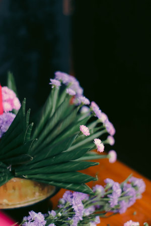 Bouquet of purple flowers on a wooden table in a cafeの写真素材