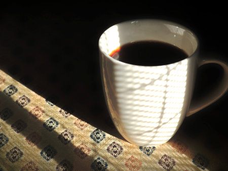 Cup of coffee with sunbeams in the morning light.の写真素材