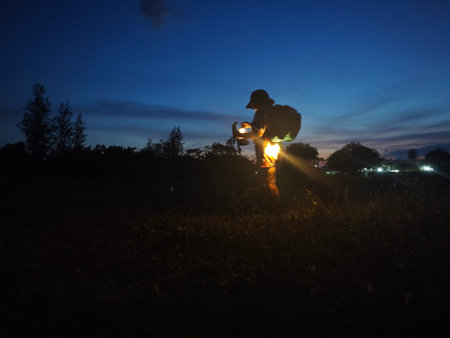 Silhouette of a girl holding a lantern in the evening.