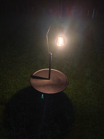 Lamp on the grass in the garden at night. Selective focus.の写真素材