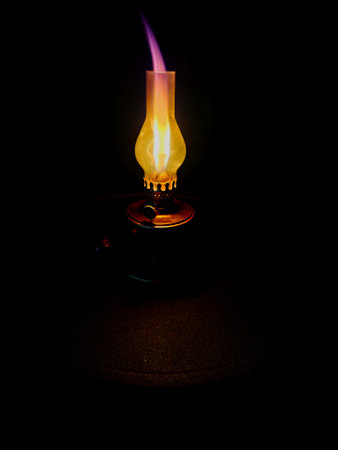 Burning oil lamp on a black background. Selective focus.の写真素材