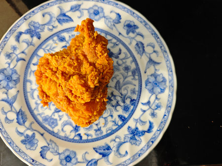 Crispy fried chicken on a blue and white porcelain plateの写真素材