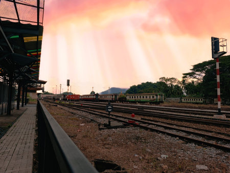 Railway station with dramatic sky at sunset. Railway station in Thailand.の写真素材