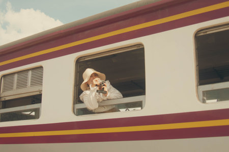 Young woman on a train at the train station. Retro style.の写真素材