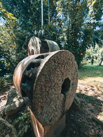 Old stone wheel in the park, close up of stone wheel.