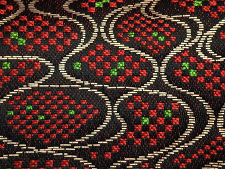 Fabric with a pattern of red and green beads. Background.