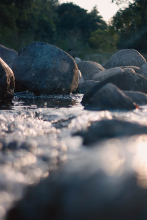 River with stones in the morning light. Soft focus, shallow DOF.