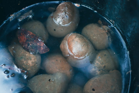 Pebbles in a bucket of water. Close-up.