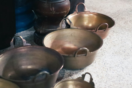 Old copper pots and pans on the counter of a restaurant, vintage styleの写真素材