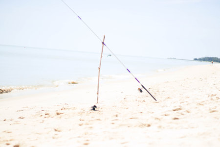 Fishing rod on the beach in summer. Selective focus.の写真素材