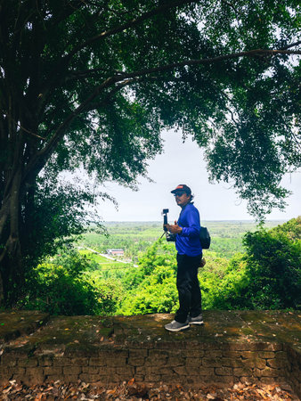Man take photo on the top of the mountain at Doi Inthanon National Park, Chiang Mai, Thailand