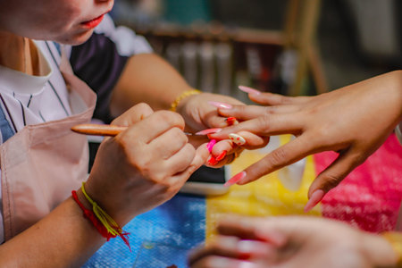 Manicure process in a beauty salon. Close-up of female hands and manicure tools.の写真素材