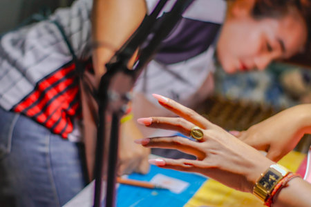 Close-up of the hands of a fashion designer working in the studioの写真素材