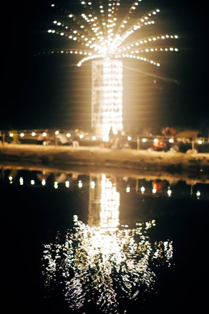 Blur image of carousel at night with bokeh effect.