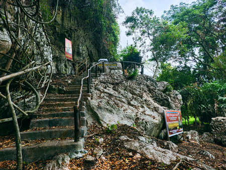Tourist climbing up the stairs to the top of the mountain in Thailand.