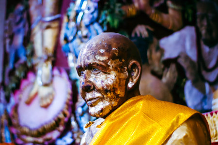 Closeup of a statue of a Buddhist monk at the Pashupatinath temple in the morningの写真素材