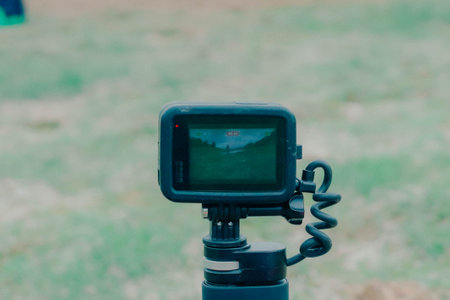 Closeup of a camera on a tripod with a blurred background.の写真素材