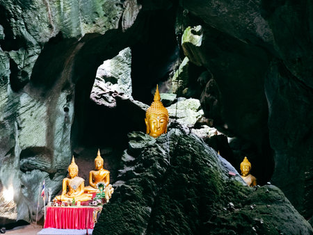 Buddha statue in the cave, Thailand. The temple is a tourist attraction.の写真素材