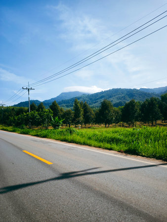 Countryside road with blue sky and white cloud,Thailand.の写真素材