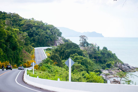 Curve road in the mountain with blue sea and sky background.の写真素材