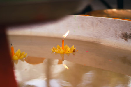 Candle in the water of the temple, closeup of photoの写真素材