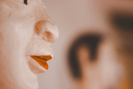 Close-up of the face of a man with an orange noseの写真素材
