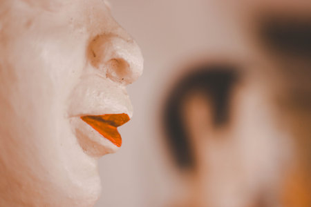 Close-up face of a man with red lips and a woman on the background